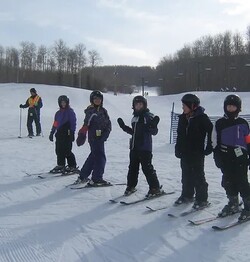 students on a ski hill with skis on